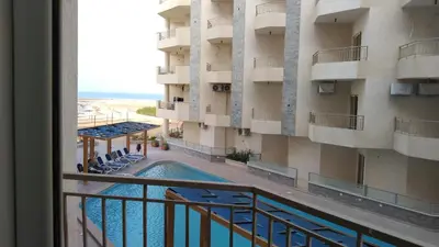 a view from a balcony of a building with a swimming pool at La Quinta Beach Resort in Hurghada