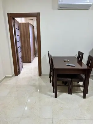 a dining room with a table and chairs and a door at La Quinta Beach Resort in Hurghada