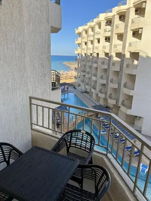 a balcony with a table and chairs and the ocean at La Quinta Beach Resort in Hurghada