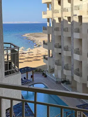 a view of the beach from the balcony of a hotel at La Quinta Beach Resort in Hurghada