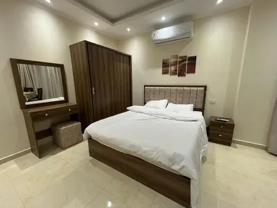 a bedroom with a large bed and a mirror at La Quinta Beach Resort in Hurghada