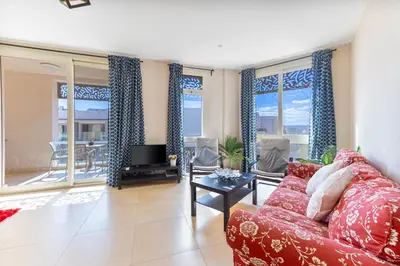 a living room with a couch and a tv at Cozy 1BR Apartment in Mangroovy with pool in Hurghada