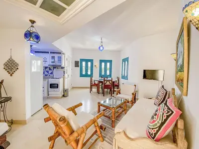 a living room with a couch and a table at 1-Bedroom Apartment in Abu Tig Marina + Roof Top in Hurghada