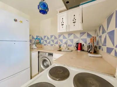 a kitchen with a sink and a washing machine at 1-Bedroom Apartment in Abu Tig Marina + Roof Top in Hurghada