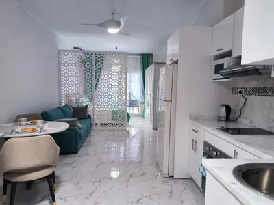 a kitchen and living room with a couch and a table at Juliana beach studio front of the beach in Hurghada