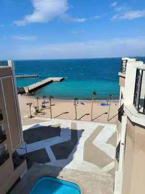 a view of the beach from the balcony of a building at Juliana beach studio front of the beach in Hurghada