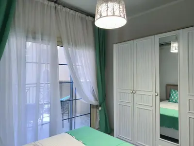 a bedroom with a bed and a chandelier at Juliana beach studio front of the beach in Hurghada