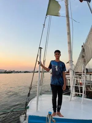 a man standing on the end of a boat at Obelisk house in Jazīrat al ‘Awwāmīyah