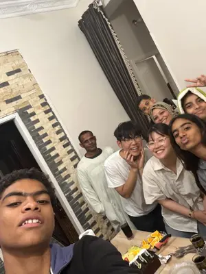 a group of people posing for a picture in a room at Obelisk house in Jazīrat al ‘Awwāmīyah