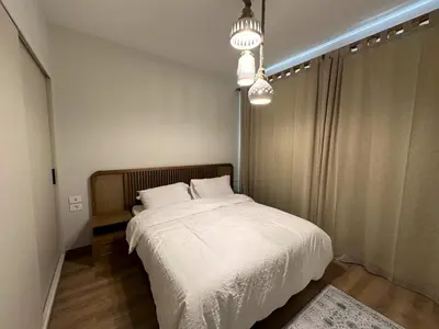 a bedroom with a large bed with white sheets at Charming 3BR Villa/Free Pool & Lagoon Access@Gouna in Hurghada