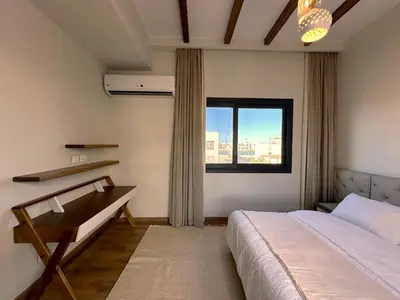 a bedroom with a bed and a large window at Charming 3BR Villa/Free Pool & Lagoon Access@Gouna in Hurghada