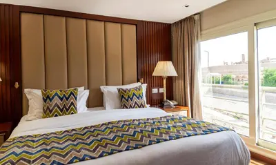 a bedroom with a large bed and a large window at Sonesta Sun Goddess Cruise Ship From Luxor to Aswan - 04 & 07 nights Every Monday in Luxor