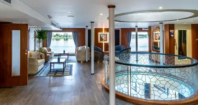 a living room with a spiral staircase on a boat at Sonesta Sun Goddess Cruise Ship From Luxor to Aswan - 04 & 07 nights Every Monday in Luxor