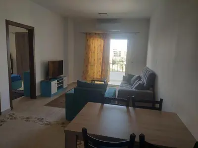 a living room with a couch and a table at Makramia 2 bedroom apartment in Hurghada