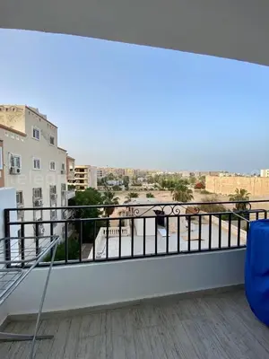 a balcony with a view of a city at Makramia 2 bedroom apartment in Hurghada