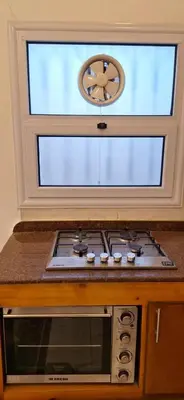 a stove top oven sitting under a window at Amenhotep Apartments in Luxor