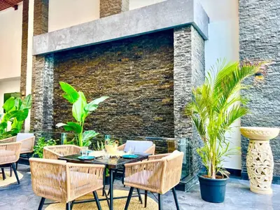 a patio with a table and chairs and a brick wall at Imperial Resort Apartment XL 1 Bed in Hurghada