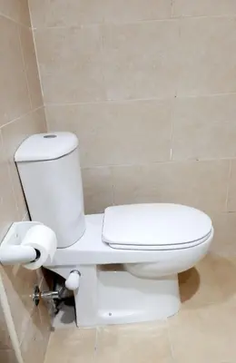 a bathroom with a white toilet in a room at Joka Aldau Heights in Hurghada