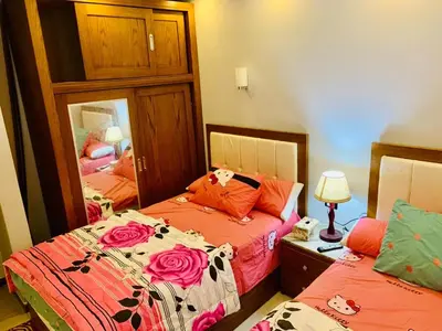 a bedroom with two beds and a mirror at plaza hurgahda in Hurghada