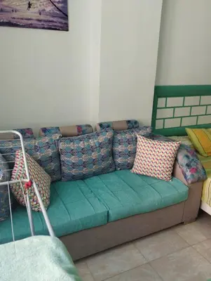 a couch with pillows on it in a room at plaza hurgahda in Hurghada