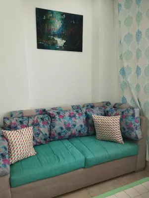 a couch with pillows sitting in a living room at plaza hurgahda in Hurghada