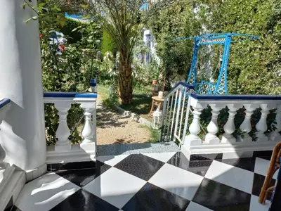 a white and blue staircase with a checkered floor at Villa Kaslan Apartments in Luxor