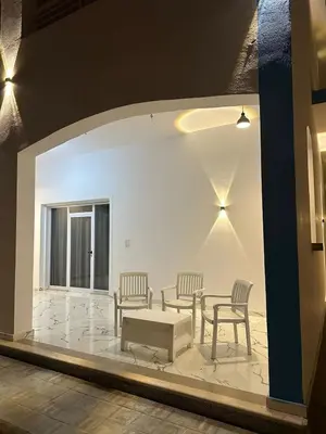 a room with two chairs and a table and a table and chairs at Al Baba Nile Villa in Luxor