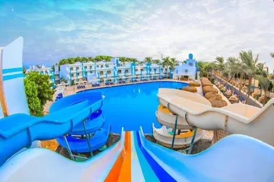 a swimming pool with a water slide at a resort at شاليه داخل ميراج اكوا بارك عائلات فقط غير مخصص للشباب in Hurghada