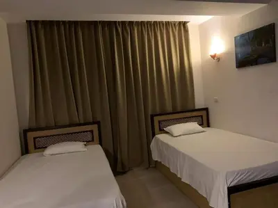 two beds sitting next to each other in a room at شاليه داخل ميراج اكوا بارك عائلات فقط غير مخصص للشباب in Hurghada