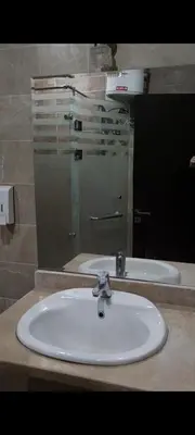 a bathroom with a sink and a mirror at شاليه داخل ميراج اكوا بارك عائلات فقط غير مخصص للشباب in Hurghada