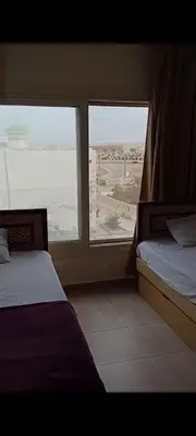 two beds in a room with a view of the ocean at شاليه داخل ميراج اكوا بارك عائلات فقط غير مخصص للشباب in Hurghada
