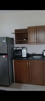 a kitchen with a refrigerator and a microwave at شاليه داخل ميراج اكوا بارك عائلات فقط غير مخصص للشباب in Hurghada