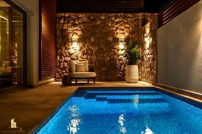 a swimming pool in front of a stone wall at 2BR beautiful home in Bali Gouna in Hurghada