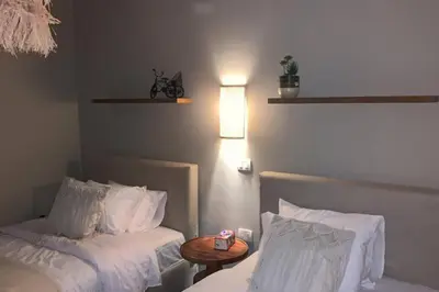 a hotel room with two beds and a table at 2BR beautiful home in Bali Gouna in Hurghada