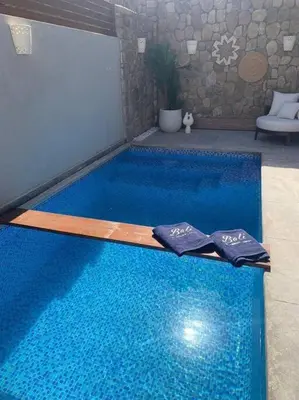 a blue swimming pool with two towels on it at 2BR beautiful home in Bali Gouna in Hurghada