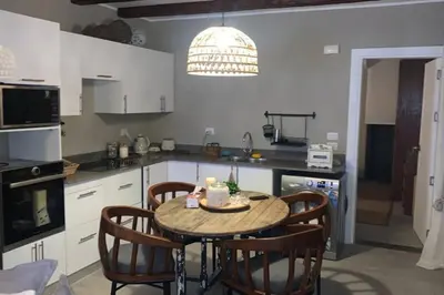 a kitchen with a table and chairs in a kitchen at 2BR beautiful home in Bali Gouna in Hurghada
