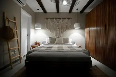 a bedroom with a large bed and two pendant lights at 2BR beautiful home in Bali Gouna in Hurghada