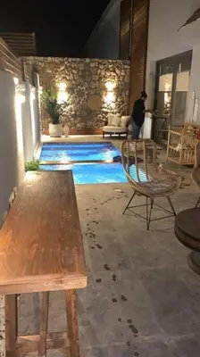 a man sitting next to a swimming pool at 2BR beautiful home in Bali Gouna in Hurghada
