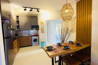 a kitchen with a wooden table with plates on it at Cozy 3 bedrooms in swan lake in Hurghada
