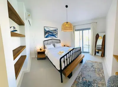 a bedroom with a large bed and a staircase at Cozy 3 bedrooms in swan lake in Hurghada