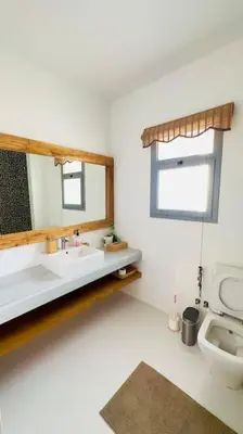 a white bathroom with a sink and a mirror at Cozy 3 bedrooms in swan lake in Hurghada