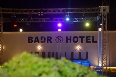 a stage with a sign that saysadi hotel at night at Badr Hotel & Resort El Kharga in Kharga