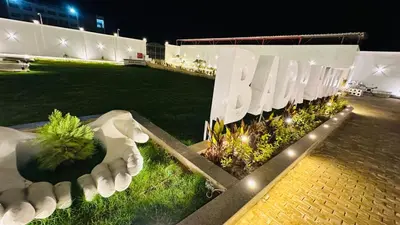 a garden at night with a fence and lights at Badr Hotel & Resort El Kharga in Kharga