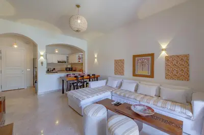 a living room with a white couch and a table at Stunning poolhouse duplex - 3 bedrooms - South Marina - El Gouna in Hurghada