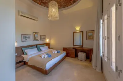 a bedroom with a bed with two stuffed animals on it at Stunning poolhouse duplex - 3 bedrooms - South Marina - El Gouna in Hurghada