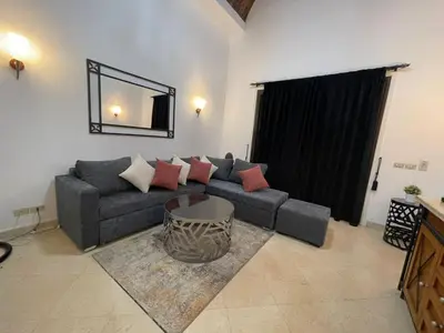 a living room with a couch and a mirror at Modernes Apartment in El Gouna - South Marina in El Gouna