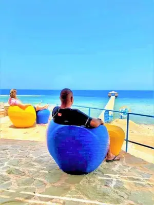 a man is sitting in an inflatable at Rohanou Beach Resort in Quseir