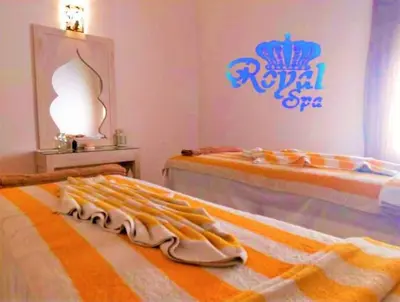 two beds in a room with a disney royal spa sign at Rohanou Beach Resort in Quseir