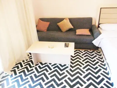 a living room with a couch and a table at Sky Relax ALDAU HEIGHTS in Hurghada