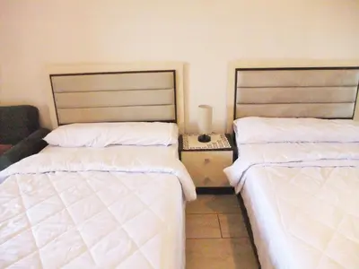 two beds sitting next to each other in a room at Sky Relax ALDAU HEIGHTS in Hurghada